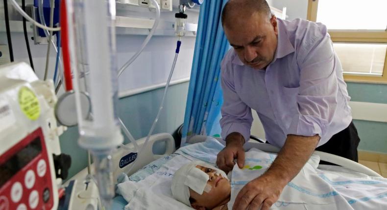 Yassir Shtewi sleeps each night by his son's bed in an Israeli hospital