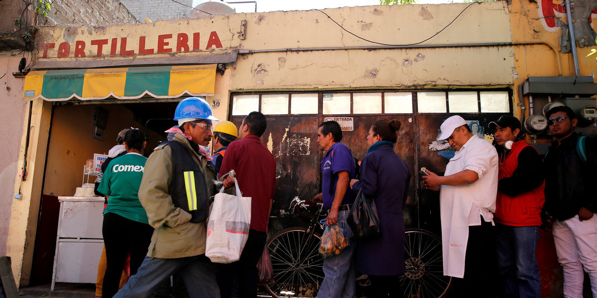 People queue to buy tortillas outside Granada market in Mexico City, Mexico, January 10, 2017.