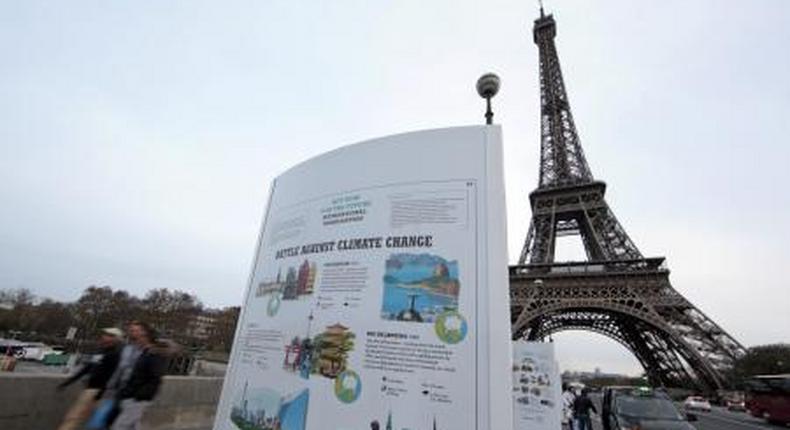 An information board about climate change is seen on a bridge near the Eiffel Tower ahead of the World Climate Conference 2015 (COP21), in Paris, France, November 28, 2015.