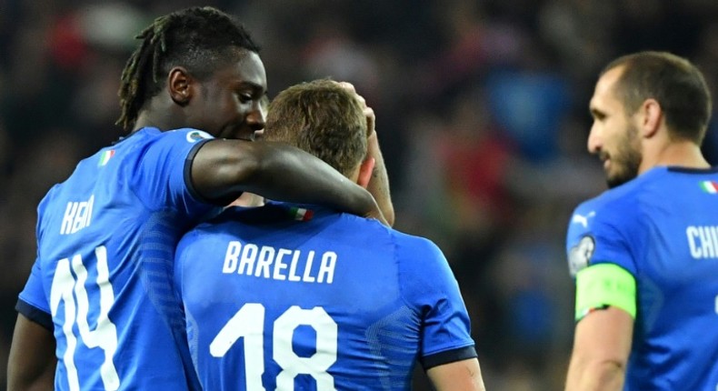 Italy's midfielder Nicolo Barella (C) and Moise Kean (L) scored in either half against Finland