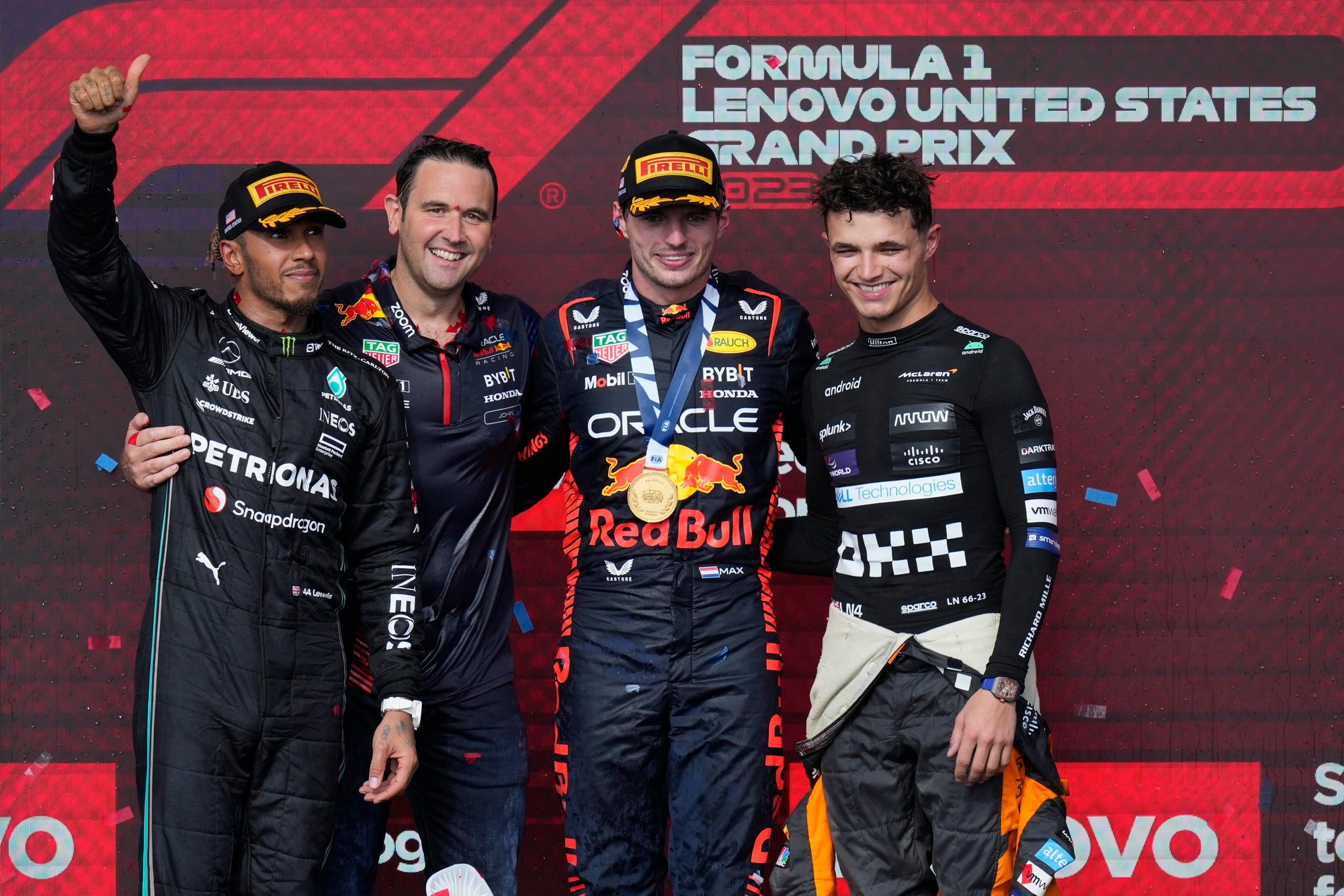 Pilot Mercedesu Lewis Hamilton (vľavo), jazdec Red Bullu Max Verstappen z Holandska a jazdec Brit Lando Norris (McLarenu) pózujú na pódiu.