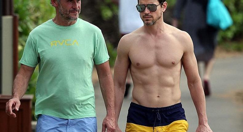 A shirtless Matt Bomer and husband Simon Halls in Hawaii