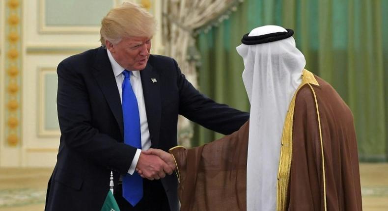 US President Donald Trump (L) shakes hands with Saudi Arabia's King Salman bin Abdulaziz al-Saud during a signing ceremony at the Saudi Royal Court in Riyadh on May 20, 2017