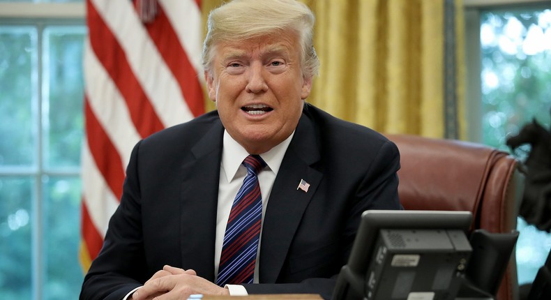 Former President Donald Trump speaks on the telephone via speakerphone in the Oval Office on August 27, 2018.