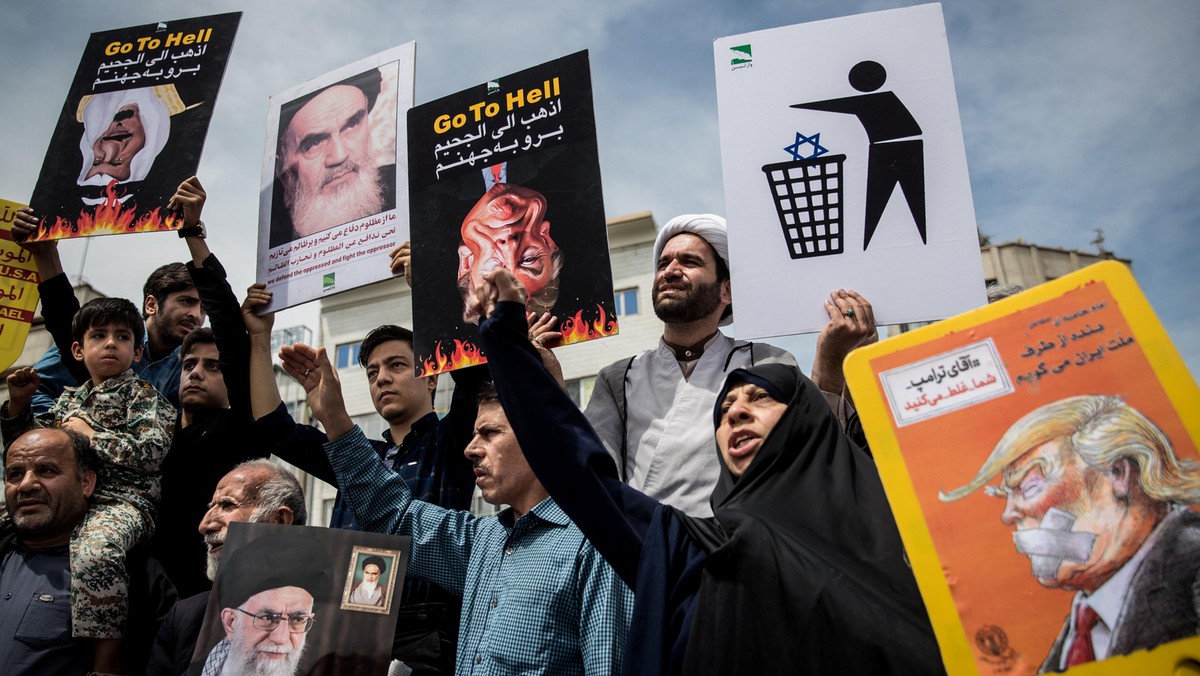 Iranians shout slogans during a protest against President Donald Trump's decision to walk out of a 2