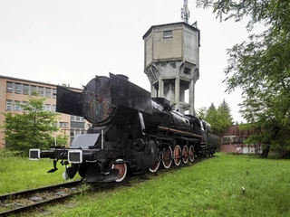 Zabytkowa lokomotywa pod dawną fabryką Fablok