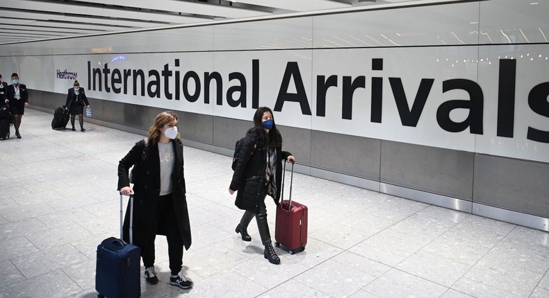 Passengers wearing face masks at London Heathrow Airport.
