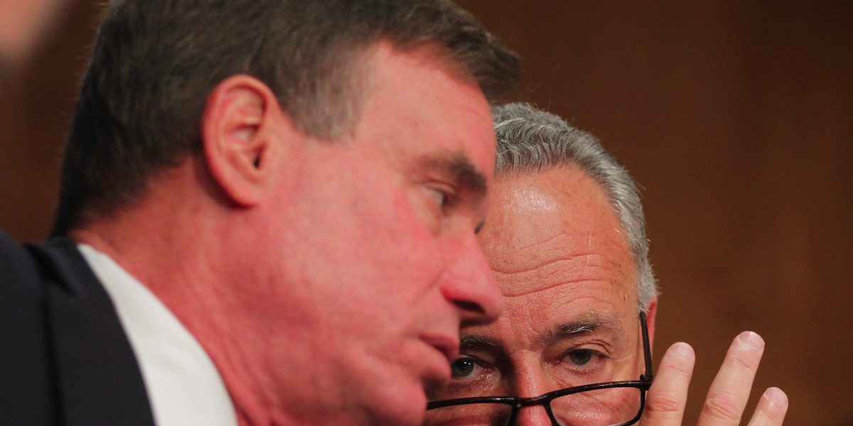 U.S. Sen. Charles Schumer (D-NY) (R) talks to Sen. Mark Warner (D-VA) (2nd R) during a hearing before Senate Banking, Housing and Urban Affairs Committee September 9, 2014 on Capitol Hill in Washington, DC.