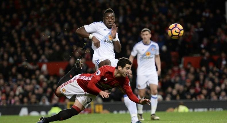 Manchester United's midfielder Henrikh Mkhitaryan (C) strikes the ball with the back of his heel to score their third goal during the English Premier League football match against Sunderland December 26, 2016