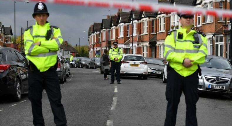 British police officers stand guard on April 28, 2017 in a residential area of north-west London, after a counter-terrorism raid during which officers shot Rizlaine Boular and arrested Khawla Barghouthi
