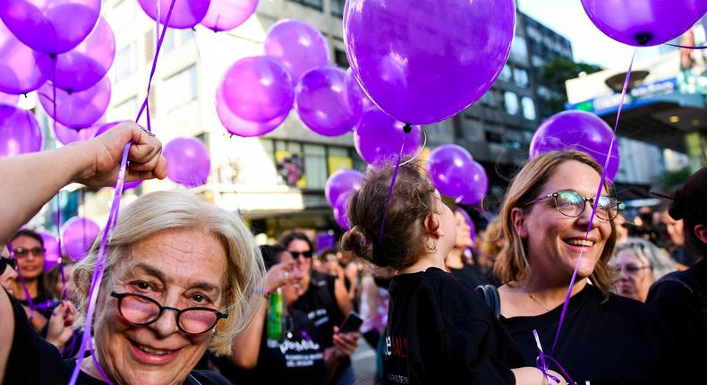 Three generations of women, Carmen Tornaria, left, her daughter Martina Gadea, right, and her granddaughter, center, attend a rally marking International Women's Day in Montevideo, Uruguay, Wednesday, March 8, 2017.