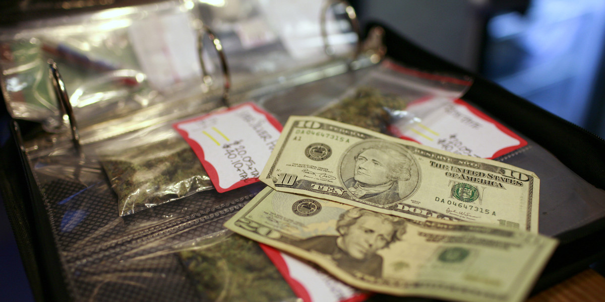 A cash transaction for medical marijuana is shown at Coffeehouse Blue Sky in Oakland, California, July 23, 2009.