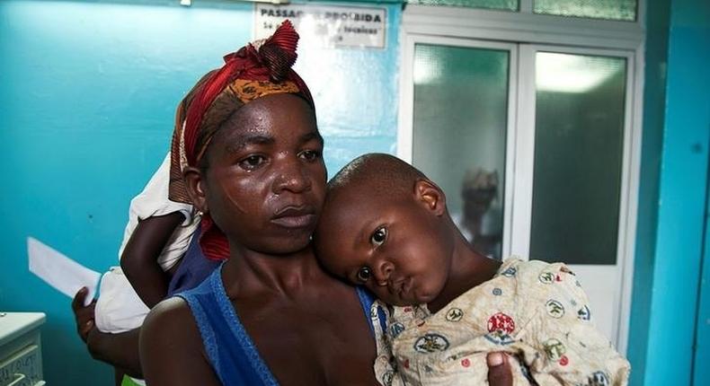 A mother holds her child suffering from yellow fever at a hospital in Luanda, Angola, March 15, 2016. 