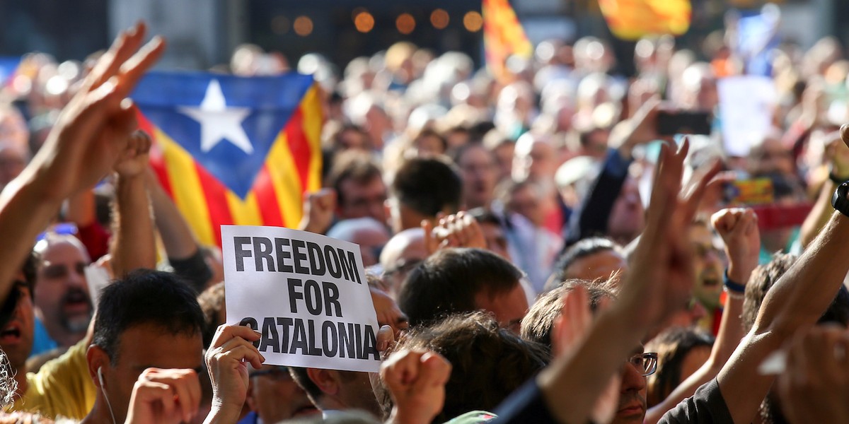 A Catalan politician posted a defiant picture of himself at his desk after being sacked by Spain