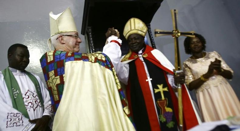 Archbishop of Canterbury Justin Welby and Ezekiel Kondo Kumir Kuku take part in a ceremony installing Kuku as Sudan's first archbishop at Khartoum's All Saints Cathedral on July 30, 2017