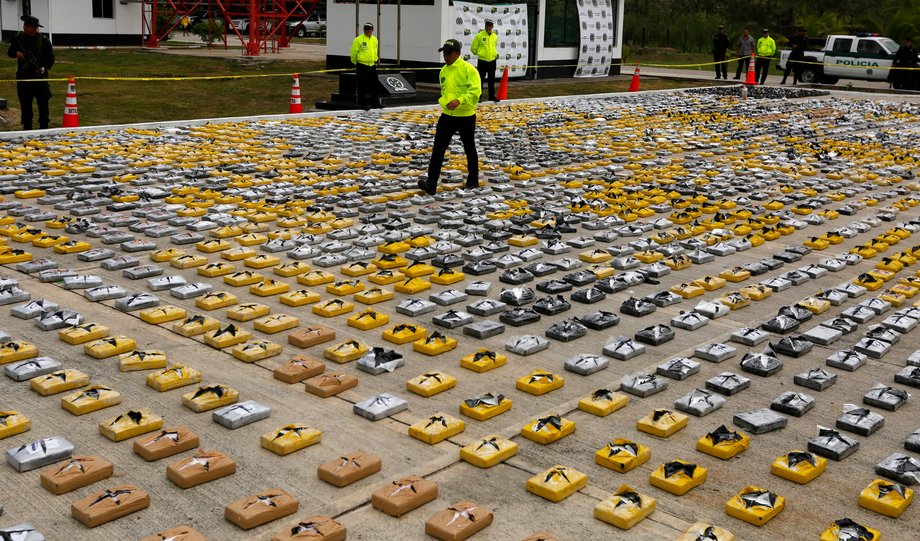 A Colombian anti-narcotics policeman walks on packs of cocaine at the police base in Necocli February 24, 2015.