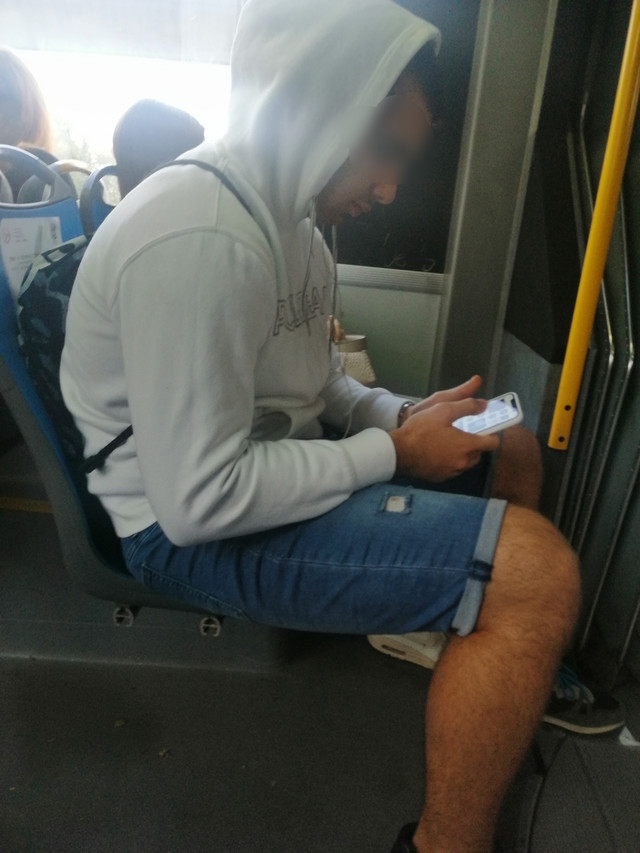 The boy without a mask on the bus