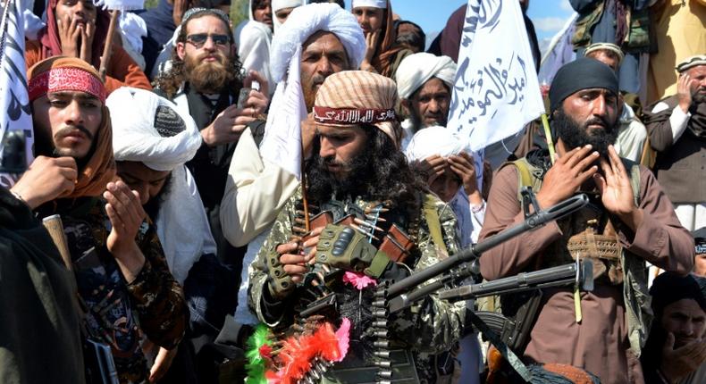 Afghan Taliban militants and villagers celebrating the deal with the US in March 2020