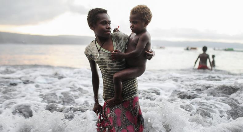 Young villagers play in the Pacific Ocean in the village of Waisisi on December 03, 2019 in Tanna, Vanuatu.