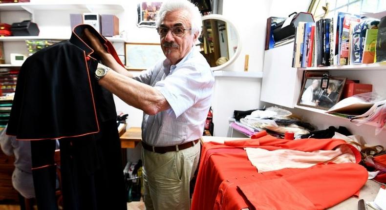 Italian tailor Raniero Mancinelli, 80, works on a cardinal robe at his workshop near the Vatican City