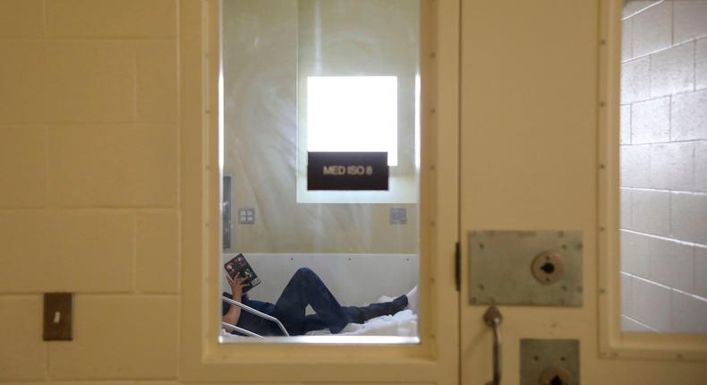 An inmate is seen reading a book in her prison cell at Las Colinas Women's Detention Facility in Santee, California.