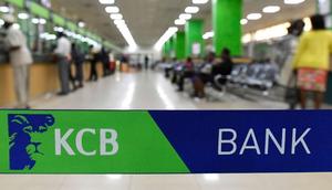 Customers are served at the Kenya Commercial Bank (KCB) in Nairobi on January 24, 2018. (Photo by SIMON MAINA/AFP via Getty Images)