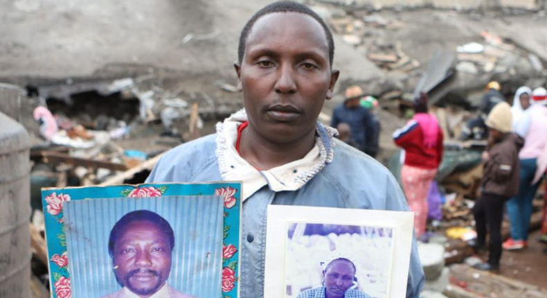 A relative holding pictures of the two victims of the Ruaka Building collapse