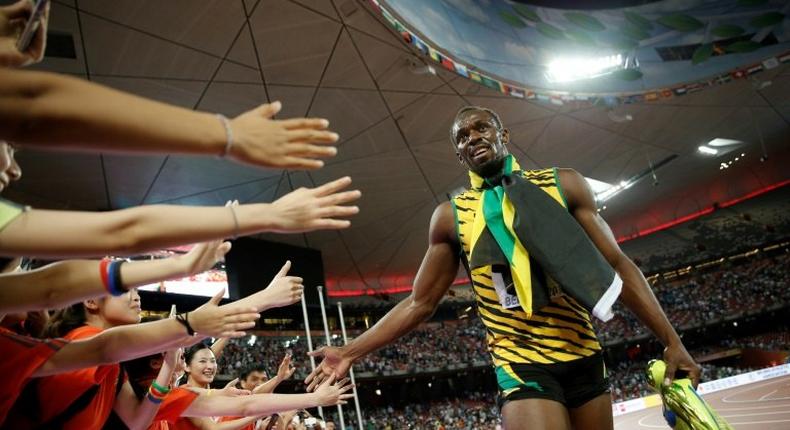 Jamaica's Usain Bolt celebrates with fans after winning the final of the 200m event at the 2015 IAAF World Championships in Beijing