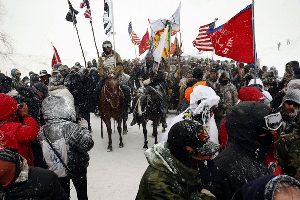 Veterans march with activists near Backwater Bridge just outside the Oceti Sakowin camp during a sno