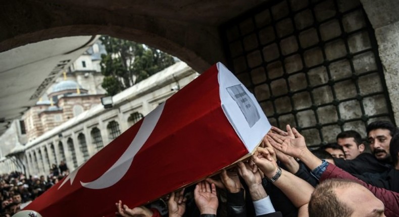 Mourners carry the coffin of Turkish police officer Hasim Usta on December 12, 2016, who was killed in the blasts outside Besiktas' Vodafone Arena football stadium in Istanbul two days earlier