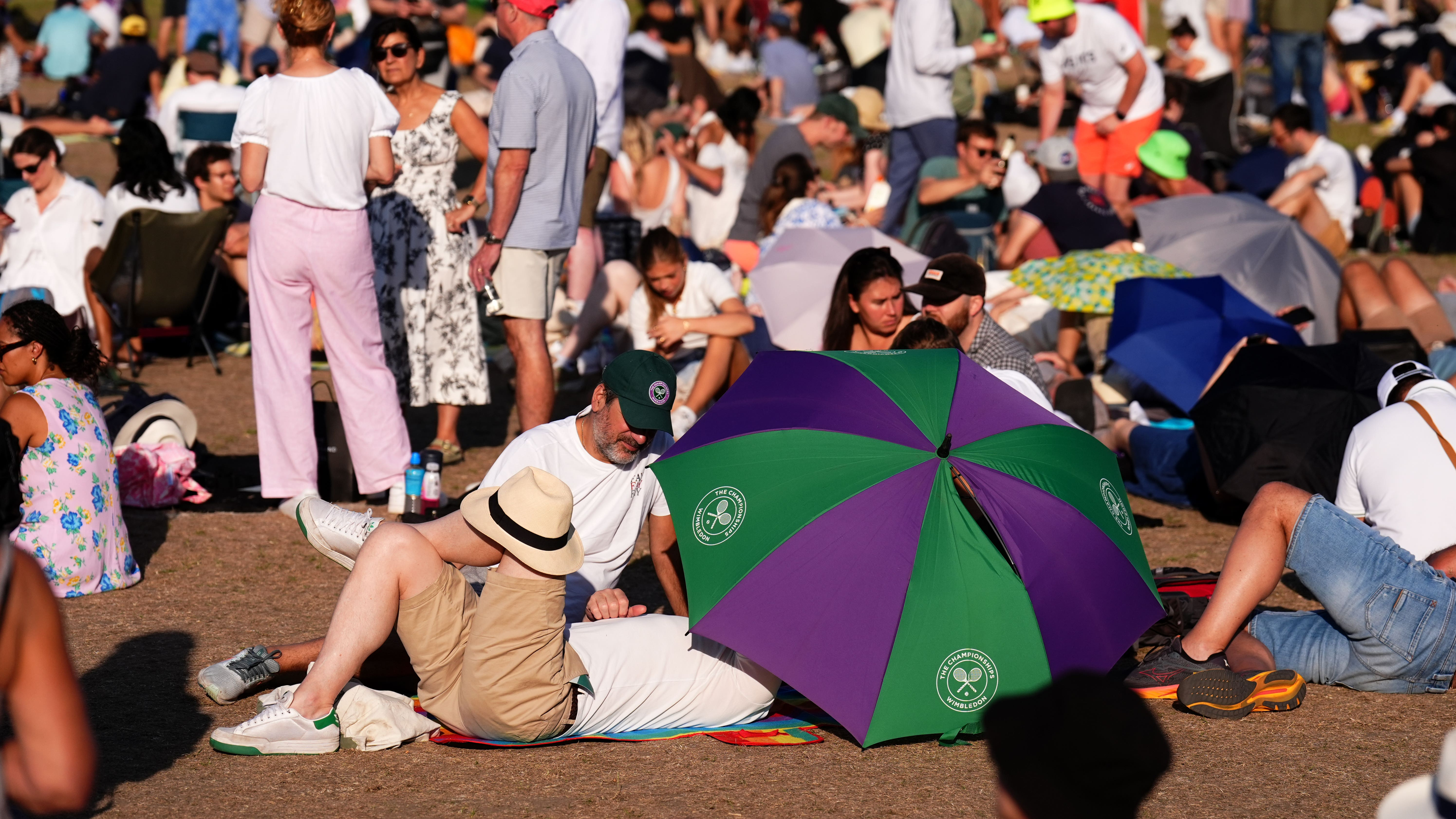 Wimbledon fans queue overnight in 34C heat with wine