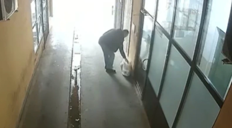 Baca smeće ispred ulaza u zgradu