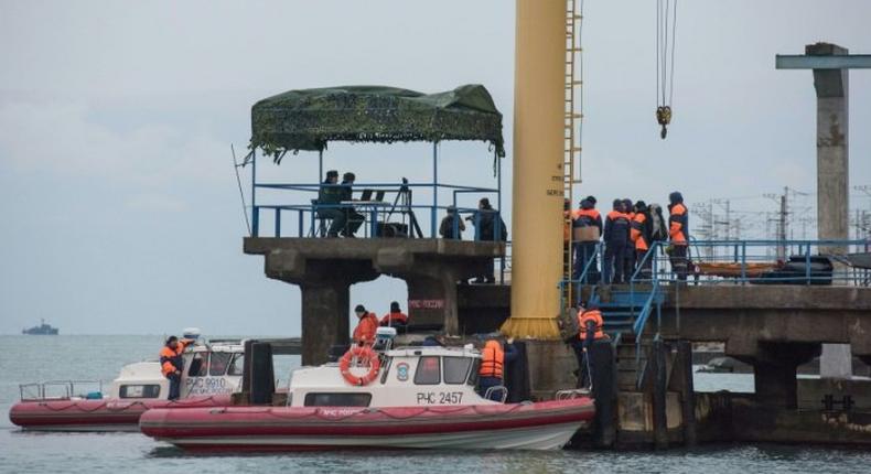 Russian rescuers gather along the shores of the Black Sea at Sochi the day after a Russian military plane crashed, on December 26, 2016