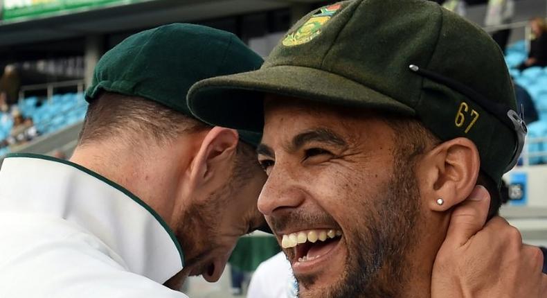 South Africa's captain Faf du Plessis (R) hugs teammate Jean-Paul Duminy as the team celebrates victory against Australia on November 15, 2016