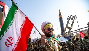 Protesters and members of the Iranian paramilitary's Basij forces march next to a ballistic missile on display during an anti-Israel rally in Tehran in November 2023.Photo by HOSSEIN BERIS/Middle East Images/AFP via Getty Images