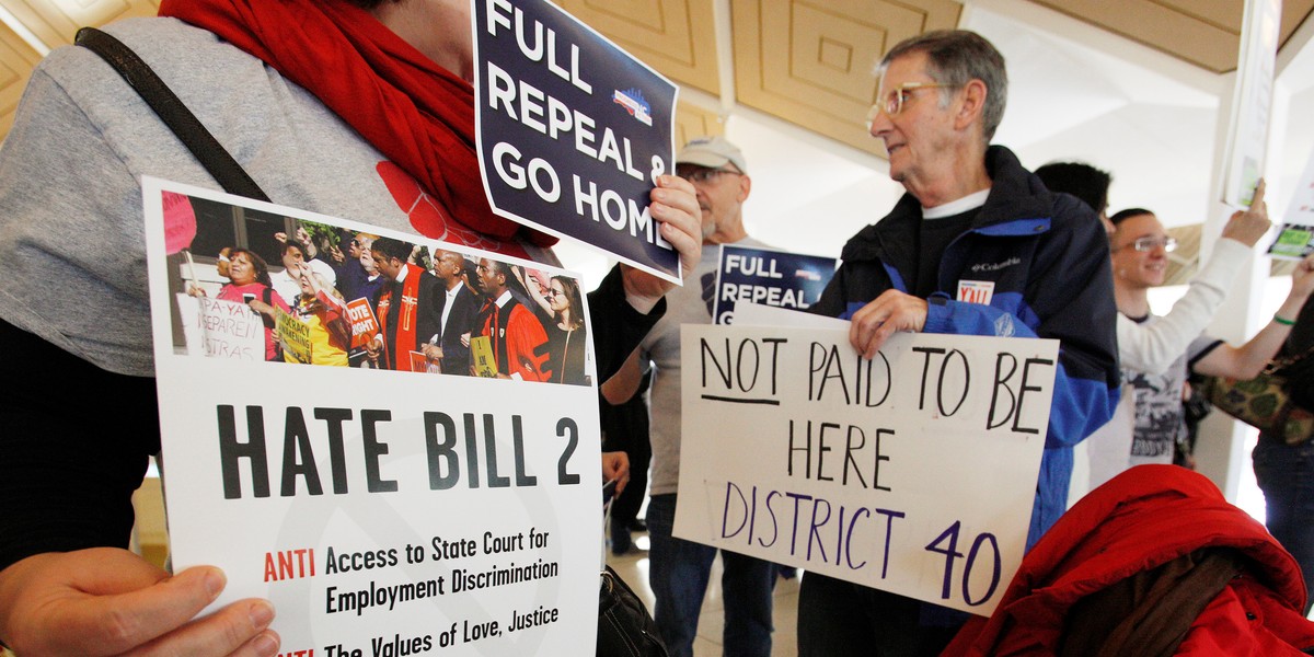 Opponents of North Carolina's HB2 law limiting bathroom access for transgender people protesting in the gallery above the state's House of Representatives chamber in Raleigh, North Carolina, on December 21.