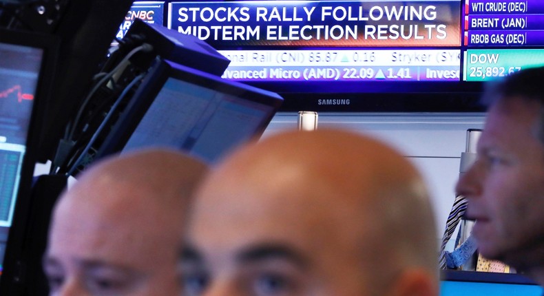 Traders work in a booth on the floor of the New York Stock Exchange, Wednesday, Nov. 7, 2018. Technology and health care stocks are leading indexes broadly higher on Wall Street as results of the midterm elections came in largely as investors had expected.