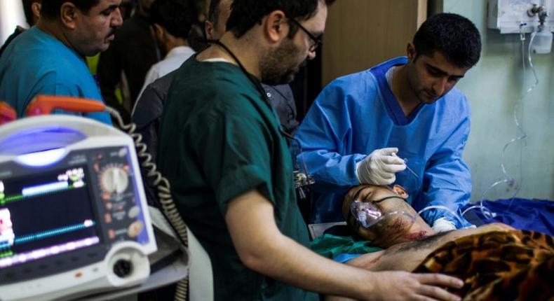 A wounded man is treated at a hospital in Iraq's Erbil after a triple car bombing at a market in Gogjali on December 22, 2016