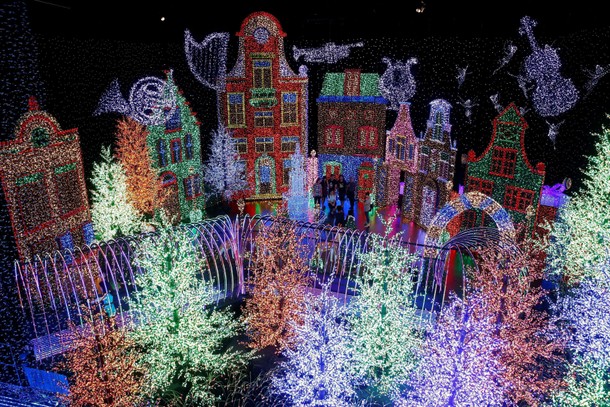 People tour a Christmas attraction featuring a display of more than 800,000 light bulbs in Universal