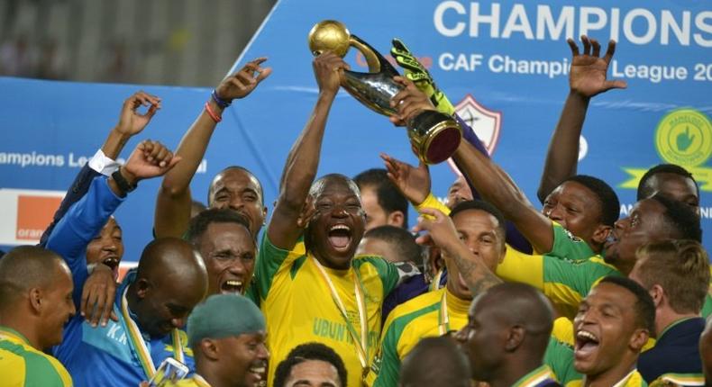 Mamelodi Sundowns' players celebrate with the trophy after winning the CAF Champions League football competition following the final match against Egypt's Zamalek on October 23, 2016