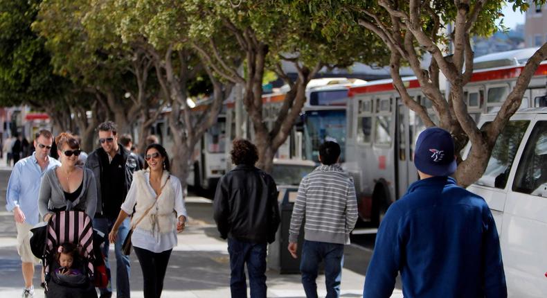 Pedestrians walk past MUNI buses on Fillmore Street in the Marina in San Francisco, Calif., a neighborhood that scores high on economic connectedness.Carlos Avila Gonzalez/Getty Images