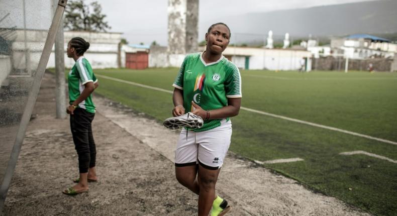 Two members of the FC Mamans national football team, Armelle Sylva and Hairiat Abdourahmane, get ready for their training session