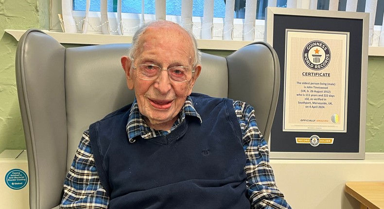 John Tinniswood and his Guinness World Records certificate for becoming the world's oldest man.Guinness World Records