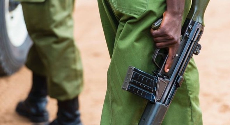 Anonymous uniformed Kenyan police officers hold guns