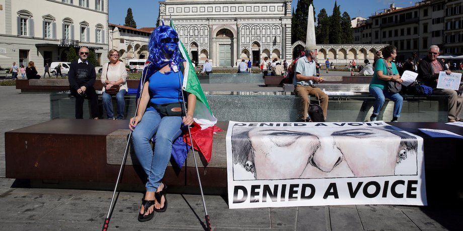 Protester waits in Florence for May's speech.