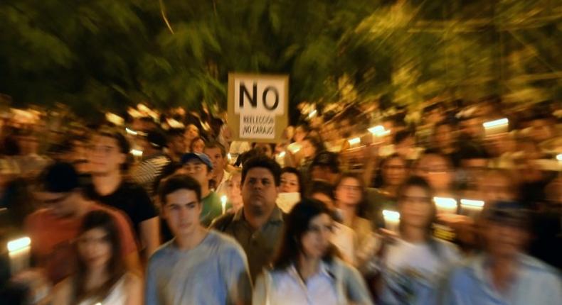 Thousands of demonstrators rally in front of the Congress in Asuncion on April 3, 2017 to protest against a bid to lift a ban on President Horacio Cartes that would allow him to be reelected