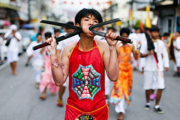 A devotee of the Chinese Ban Tha Rue shrine takes part in a procession celebrating the annual vegeta