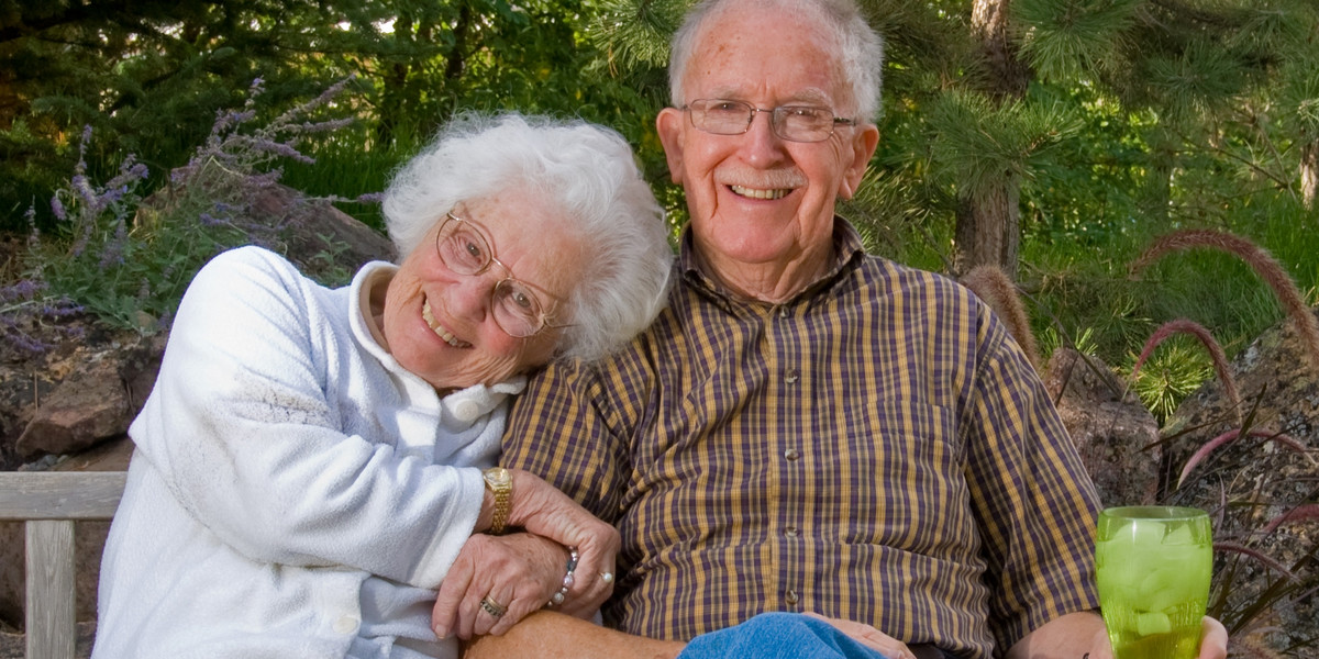 Elderly man and woman sitting on a bench