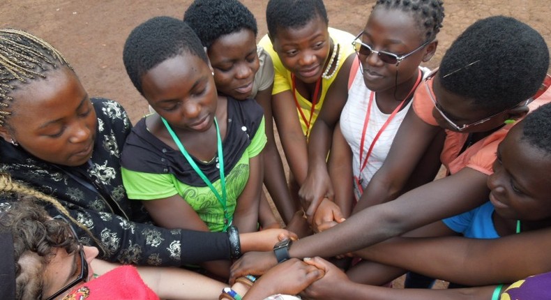 African girls holding hands to signify peace