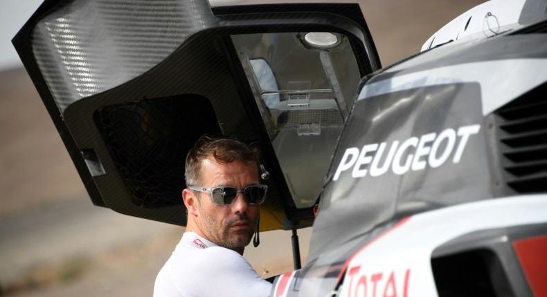 Peugeot's French driver Sebastien Loeb gets ready for a start of the Silk Way 2017 between Urumqi and Hami China, on July 17, 2017